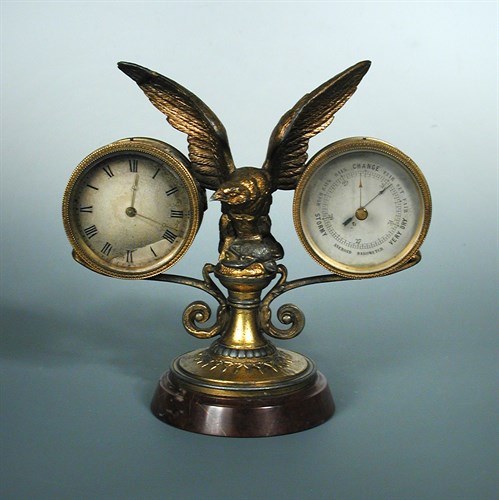 Lot 209 - A gilt spelter mounted desk timepiece and aneroid barometer