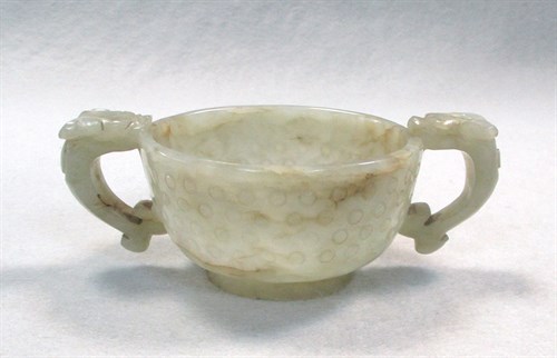 Lot 249 - A small jade twin handled cup, 19th century
