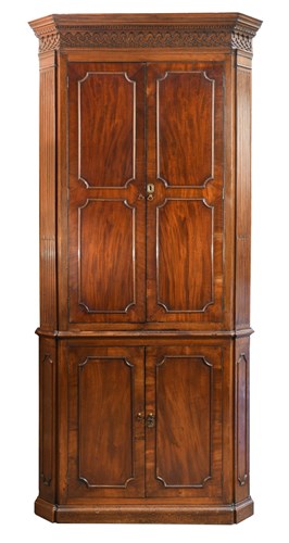 Lot 375 - A George III mahogany corner cupboard