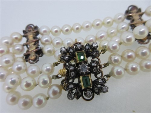 Lot 267 - A three row cultured pearl bracelet with 18th...