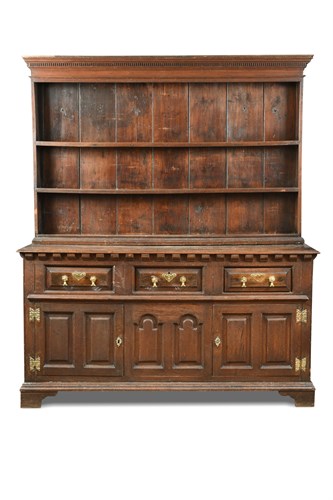 Lot 319 - An 18th century oak dresser, with a boarded...