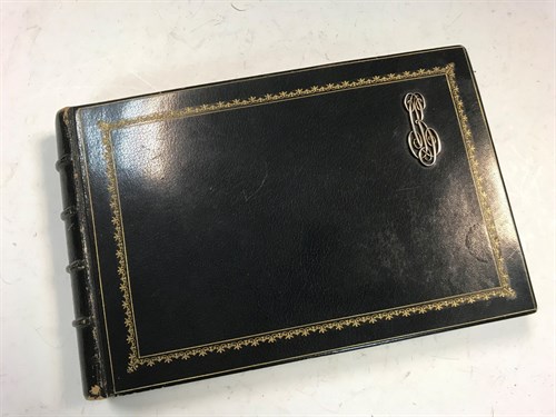 Lot 178 - A collection of crests in monogrammed leather album