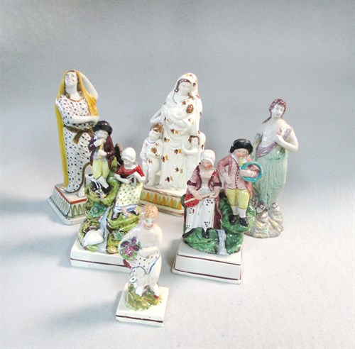 Lot 13 - Two Staffordshire pottery figures emblematic of Hope and Charity