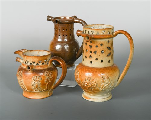 Lot 14 - A 19th century Derbyshire salt glazed pottery puzzle jug