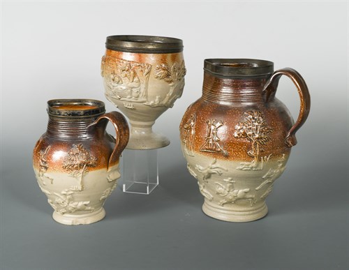 Lot 16 - An early 19th century salt glazed metal mounted jug
