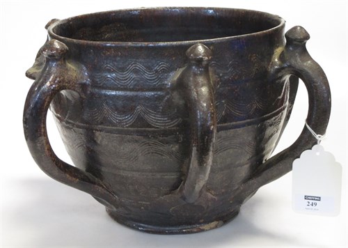 Lot 249 - An early earthenware multihandled vessel, 8in...