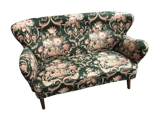Lot 515 - In the manner of Finn Juhl, a small wing back two-seat sofa