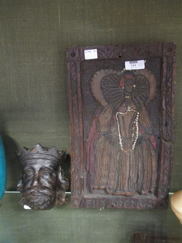 Lot 244 - A carved oak head of a king and a carved panel...