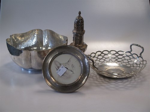 Lot 295 - A silver photo frame, a bowl with hammered...