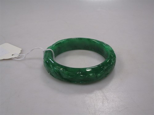 Lot 266 - A carved jade bangle