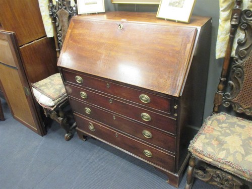 Lot 609 - A George III mahogany bureau, with oval brass...