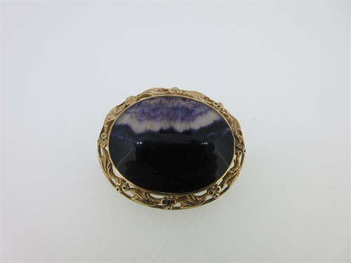 Lot 163 - An oval blue john brooch set in gold