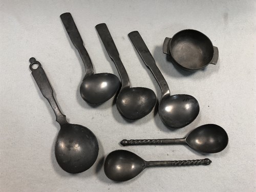 Lot 392 - A set of three pewter shaped serving spoons
