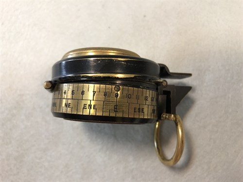 Lot 373 - A Barker's Patent brass and black enamel prismatic compass, dated 1910