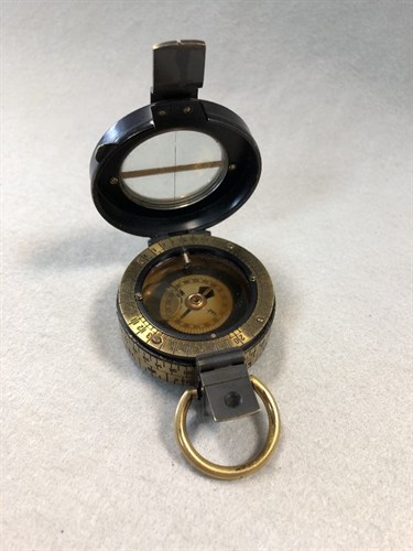 Lot 373 - A Barker's Patent brass and black enamel prismatic compass, dated 1910