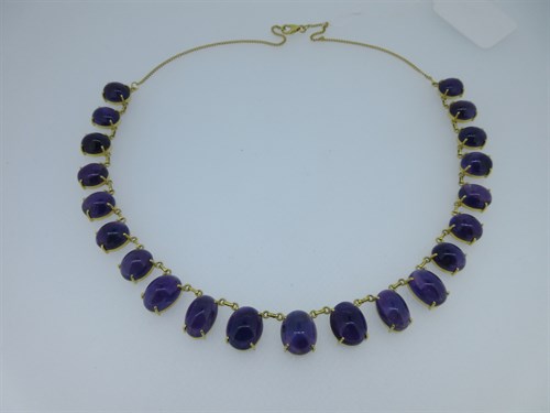 Lot 165 - A necklace of oval amethysts