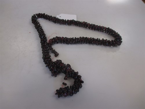Lot 298 - A twisted rope necklace of garnet beads (A/F)