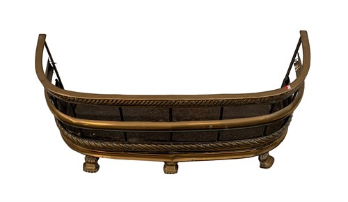 Lot 85 - A late Regency brass fender on shaped feet,...