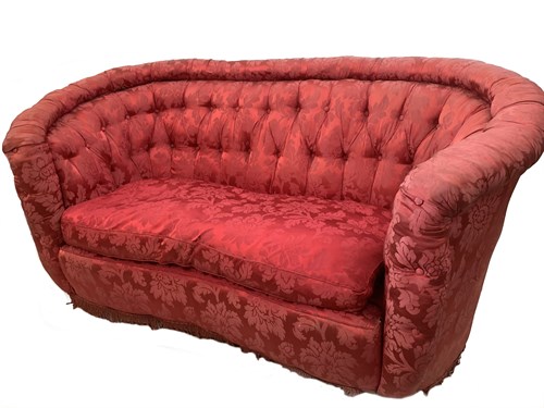 Lot 89 - A sofa of concave outline, button upholstered...