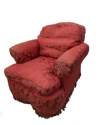 Lot 86 - A low back armchair upholstered in a dark...