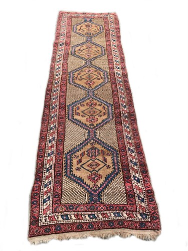 Lot 12 - A Persian camel ground runner in the Kazak...