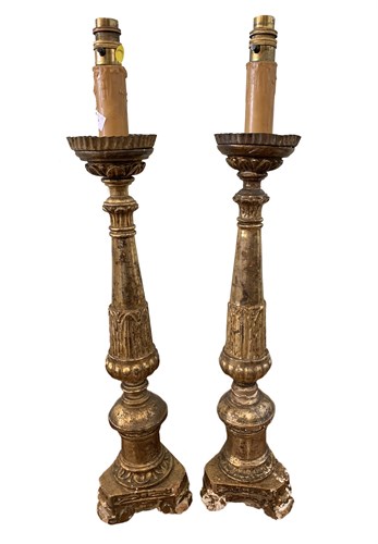 Lot 74 - A pair of Continental carved giltwood pricket...