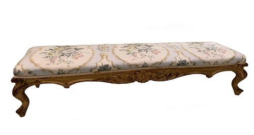 Lot 61 - A giltwood framed long footstool, on swept...