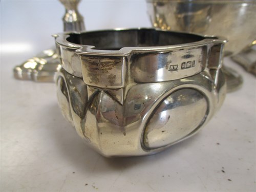 Lot 375 - A pair of silver candlesticks with loaded...