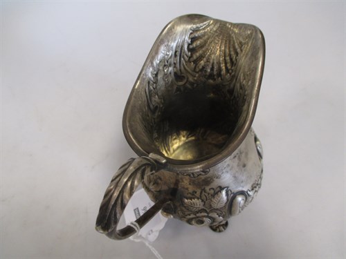 Lot 366 - A silver embossed milk jug, rubbed, 6oz
