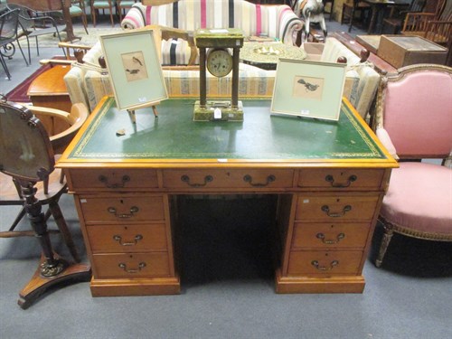 Lot 549 - A pale wood twin pedestal desk with green...