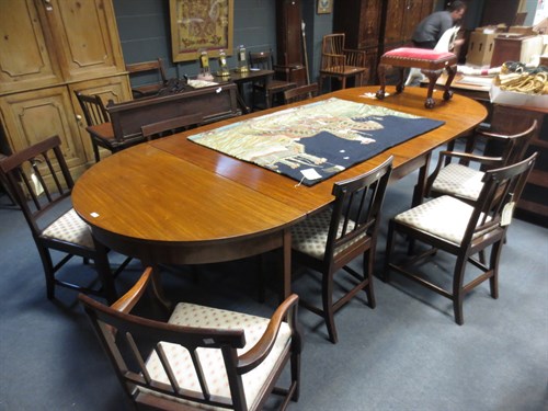 Lot 710 - A Georgian D end extending mahogany table with...
