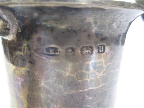 Lot 358 - A silver half pint tankard by A E Jones, hammered finish