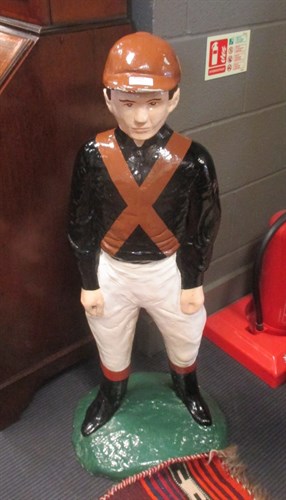 Lot 232 - A painted reconstituted model of a jockey in...