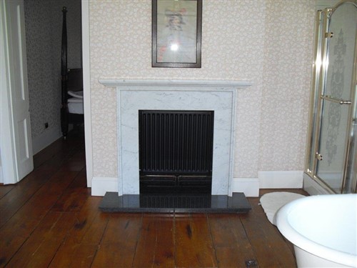 Lot 593 - A 19th Century variegated Carrera white marble fireplace