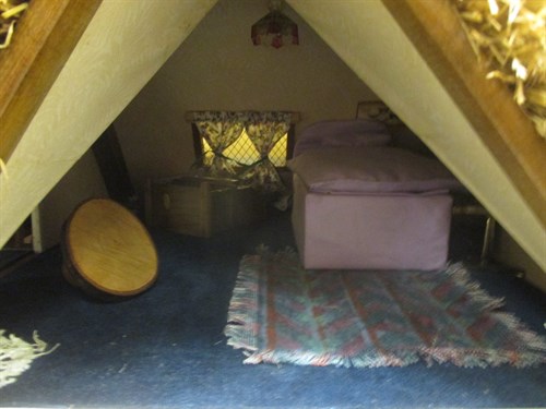 Lot 216 - A Thatched doll's cottage, the front with two...