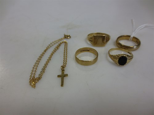 Lot 303 - Four 9ct gold rings and a 9ct gold cross on a...