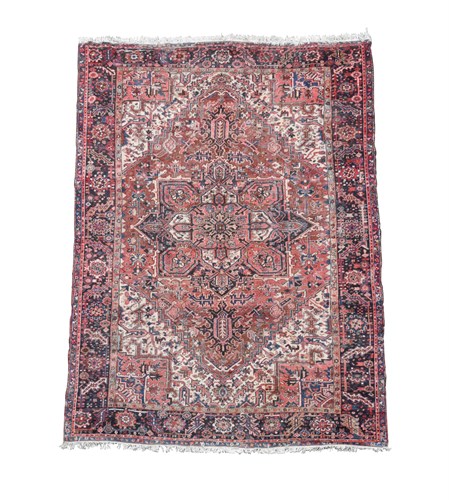 Lot 748 - A Heriz pink, ivory and blue ground carpet,...