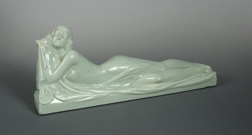 Lot 72 - Marines-France, an Art Deco pastel green glazed pottery figure of a recumbent female nude