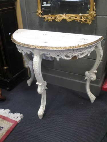 Lot 353 - A painted and gilded demi-lune console table...