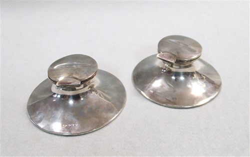 Lot 248 - A pair of Edward VII silver capstan inkwells