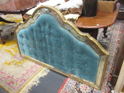 Lot 627 - A padded headboard with mirrored panel border...