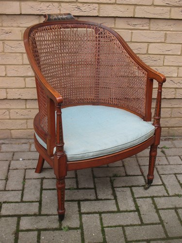 Lot 633 - An Edwardian painted satinwood bergere
