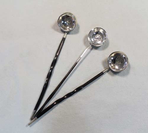 Lot 445 - A pair of punch ladles each set with a George II coin, and another example
