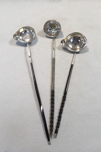 Lot 446 - Three punch ladles each set with a George II coin