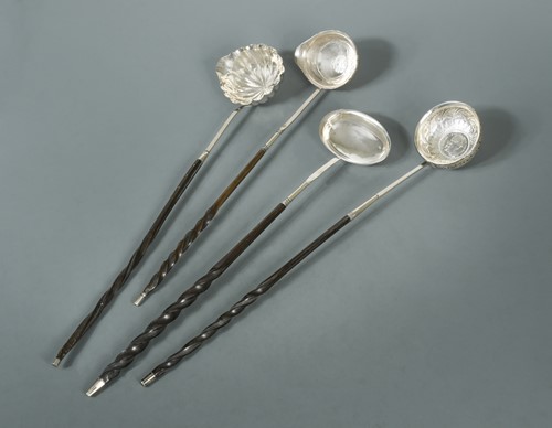 Lot 430 - A collection of four punch ladles, one set with a Charles II coin