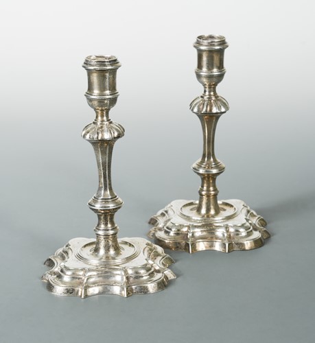 Lot 447 - Two almost matching George II cast silver candlesticks