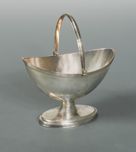 Lot 472 - A George III silver swing handled sugar basket by Henry Chawner