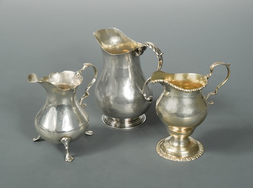 Lot 454 - Two George II silver cream jugs together with a George III example