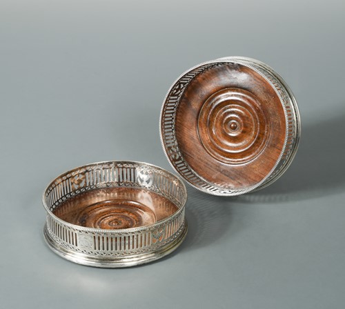 Lot 471 - A Pair of George III silver bottle coasters