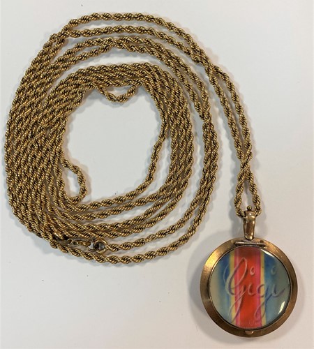 Lot 21 - A long guard chain together with a double sided locket